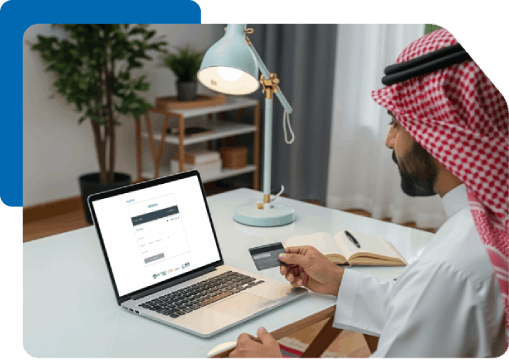 Arab man using laptop and credit card for online purchase or payment.